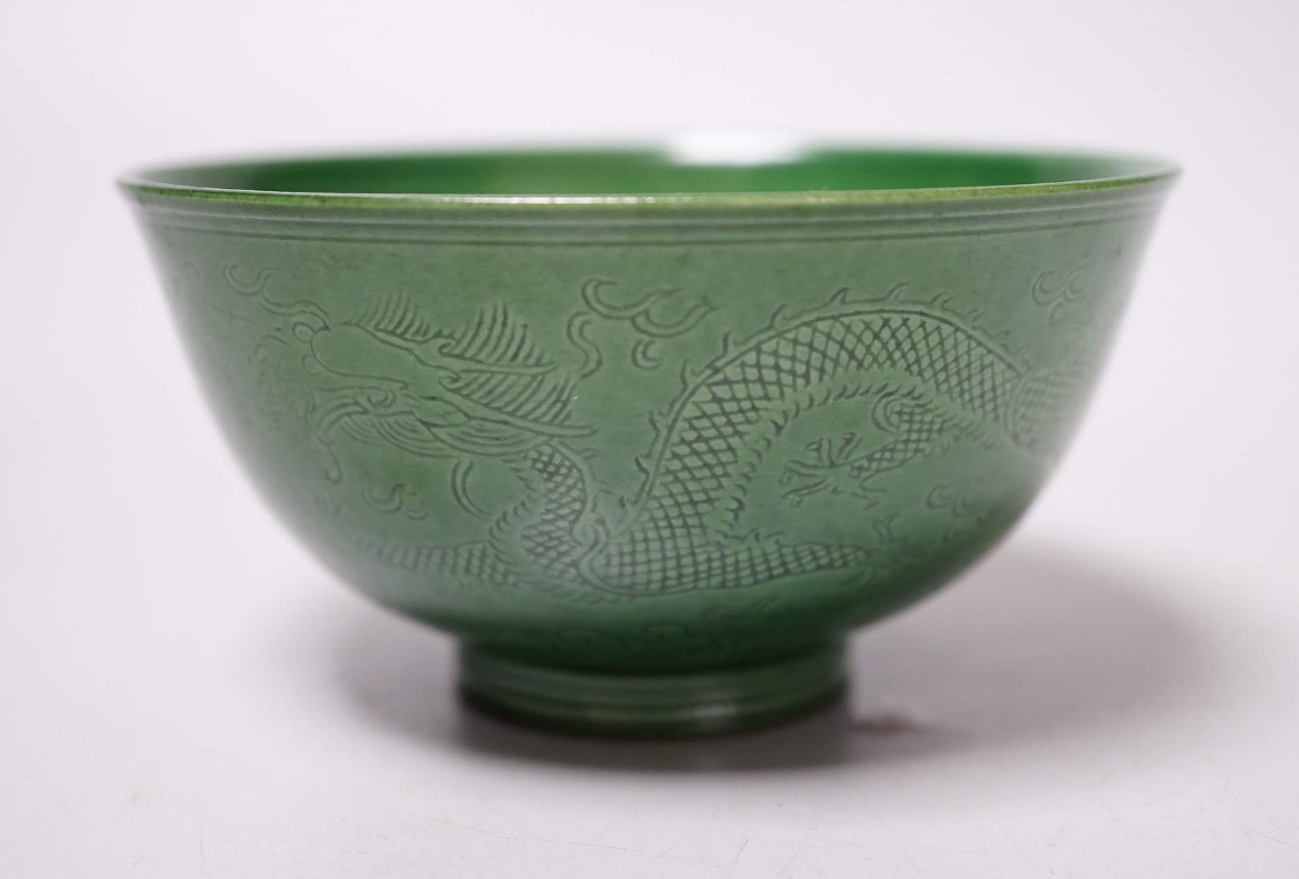 A Chinese green glazed ‘dragon’ tea bowl, 10cm diameter
